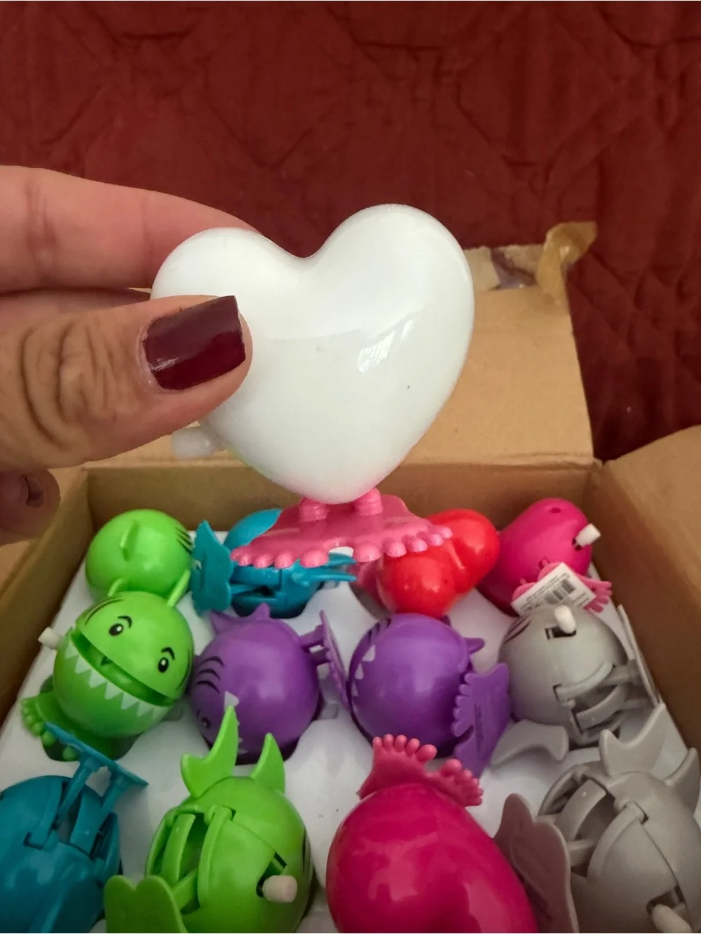 Assorted colors of sharks and hearts wind up toys .